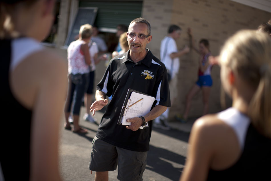 A Penn High School coach talks to runners during the Bremen girl's track and field sectionals on Tuesday, May 15, 2012, at Bremen High School. (James Brosher/South Bend Tribune)