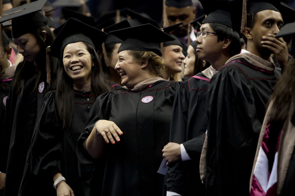 Soon-to-be graduates share a laugh after making their way into the arena during Indiana University-South Bend commencement exercises on Tuesday, May 8, 2012, in the Purcell Pavilion at Notre Dame. (James Brosher/South Bend Tribune)