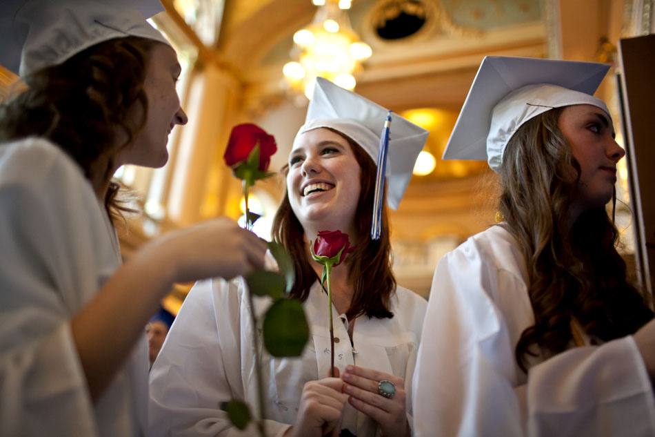 Molly O'Leary, center, shares a laugh with fellow Marian High School classmates as they prepare to march in the school's commencement exercises on Friday, May 25, 2012, at the Morris Performing Arts Center in South Bend. (James Brosher/South Bend Tribune)