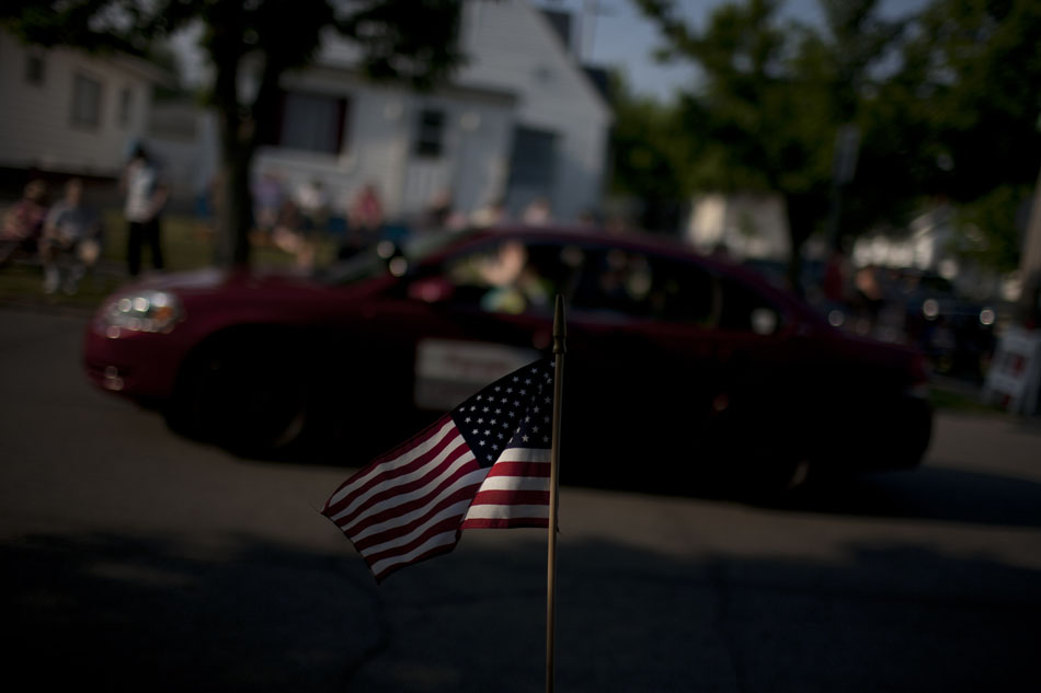 A parade spectator waves an American Flag during the Westside Memorial Day Parade on Monday, May 28, 2012, in South Bend. (James Brosher/South Bend Tribune)