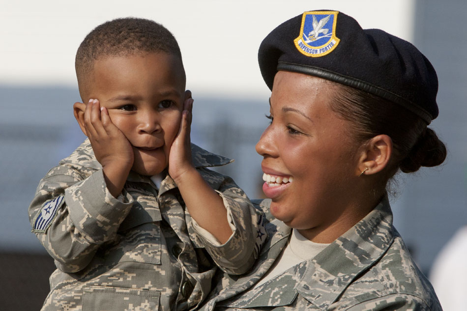 A United States Air Force servicewoman marches with her son during the Westside Memorial Day Parade on Monday, May 28, 2012, in South Bend. (James Brosher/South Bend Tribune)