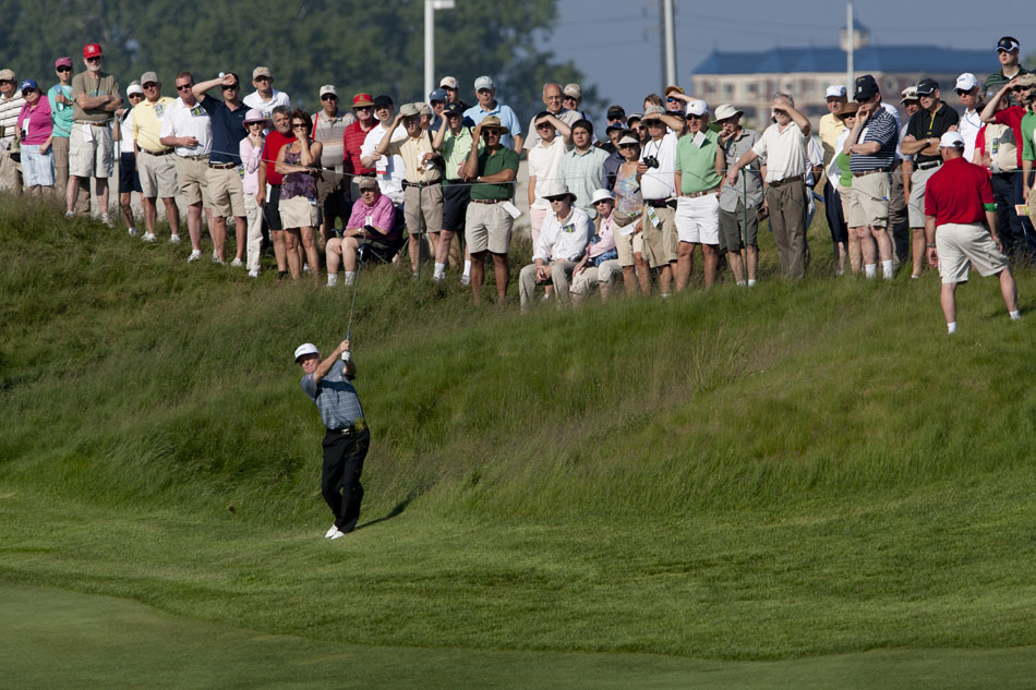 Spectators watch as Jeff Sluman hits a shot to the green from the rough along the 5th fairway during the opening round of the Senior PGA Championship on Thursday, May 24, 2012, at Harbor Shores in Benton Harbor, Mich. (James Brosher/South Bend Tribune)