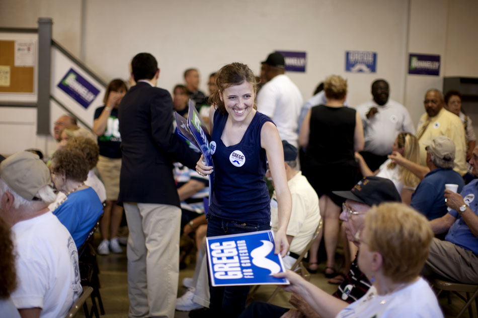 A campaign worker hands out signs for John Gregg, the Democratic candidate for governor, during a "Workhorse Tour" stop on Saturday, May 19, 2012, at UAW Local 9 in South Bend. (James Brosher/South Bend Tribune)