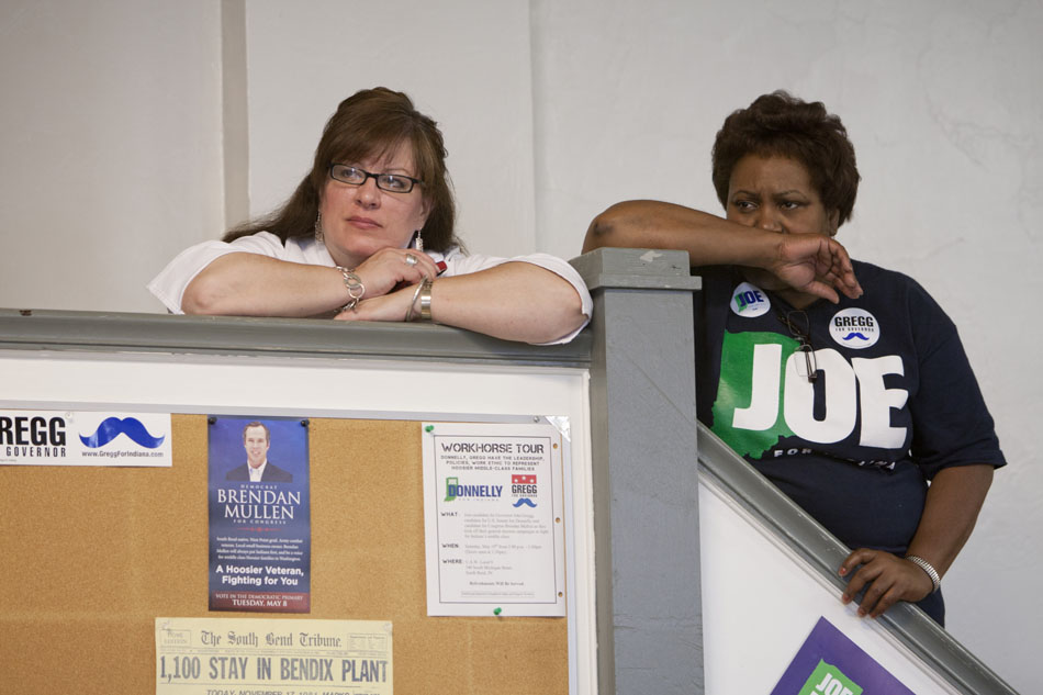 Members of the audience listen to the speakers from a set of stairs during a "Workhorse Tour" stop on Saturday, May 19, 2012, at UAW Local 9 in South Bend. (James Brosher/South Bend Tribune)