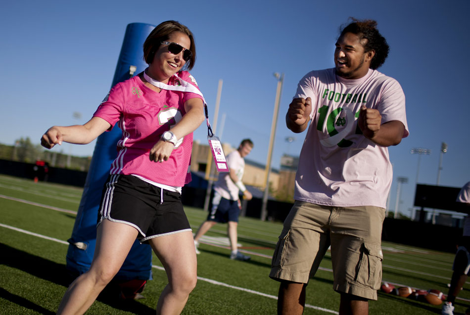 Beth Hunter of Granger shows off her defensive sack dance with Notre Dame defensive end Kona Schwenke during a Football 101 clinic on Tuesday, June 12, 2012, at Notre Dame. The clinic for women was hosted by the Kelly Cares Foundation with proceeds going to breast cancer prevention and awareness. (James Brosher/South Bend Tribune)