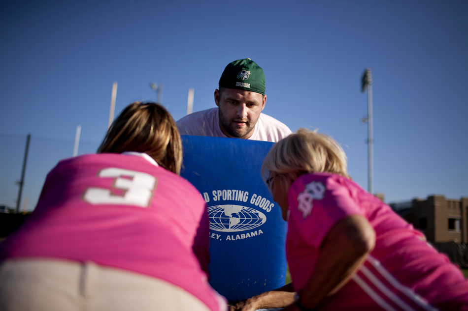 Notre Dame center Mike Golic Jr. takes on a double team of women as he shows them a blocking drill during a Football 101 clinic on Tuesday, June 12, 2012, at Notre Dame. (James Brosher/South Bend Tribune)
