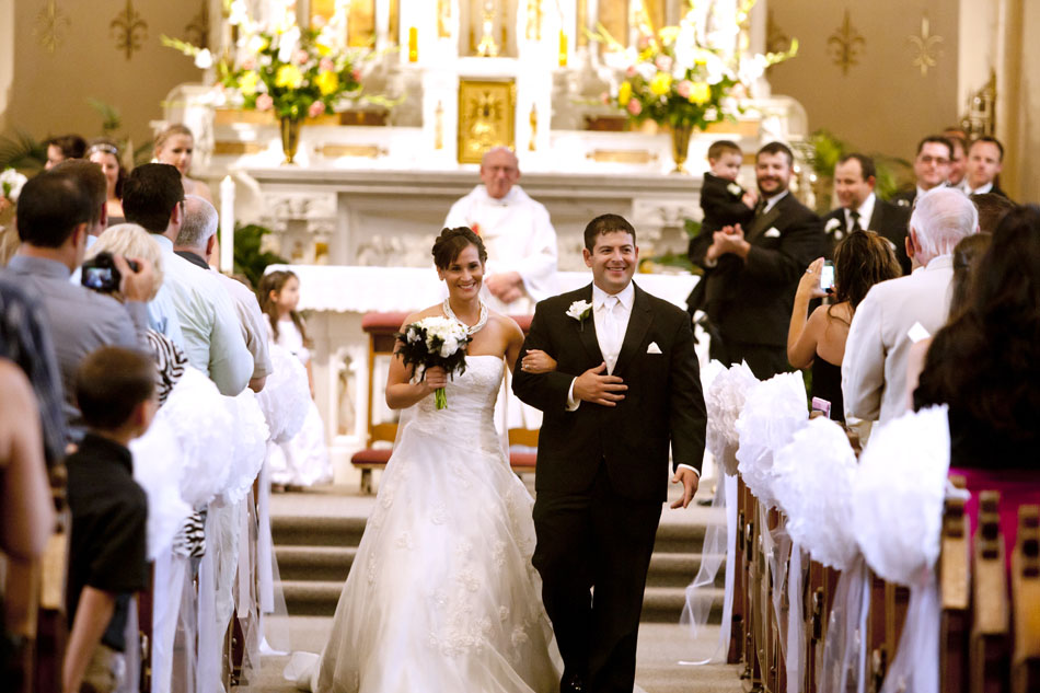 Jackie Nisley and Alfredo Alvarado make their way down the aisle after their wedding ceremony on Saturday, June 16, 2012, at St. Joseph Parish in Mishawaka. (James Brosher/South Bend Tribune)