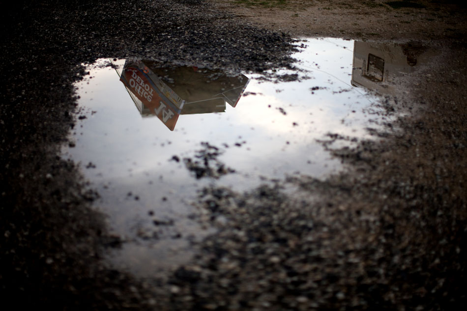 The wing of NASCAR driver Tony Stewart's No. 14 sprint car is reflected in a puddle of water on Saturday, June 16, 2012, at Plymouth Speedway. (James Brosher/South Bend Tribune)
