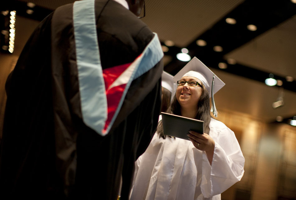 A graduate receives her diploma from George McCullough Jr., the school principal, during Washington High School commencement exercises on Saturday, June 9, 2012, at the Century Center in downtown South Bend. (James Brosher/South Bend Tribune)