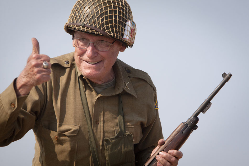 A U.S. re-enactor gives a thumbs up to the crowd after taking out a German artillery position during a WWII re-enactment on Saturday, June 30, 2012, at Tiscornia Beach in St. Joseph, Mich. (James Brosher/South Bend Tribune)