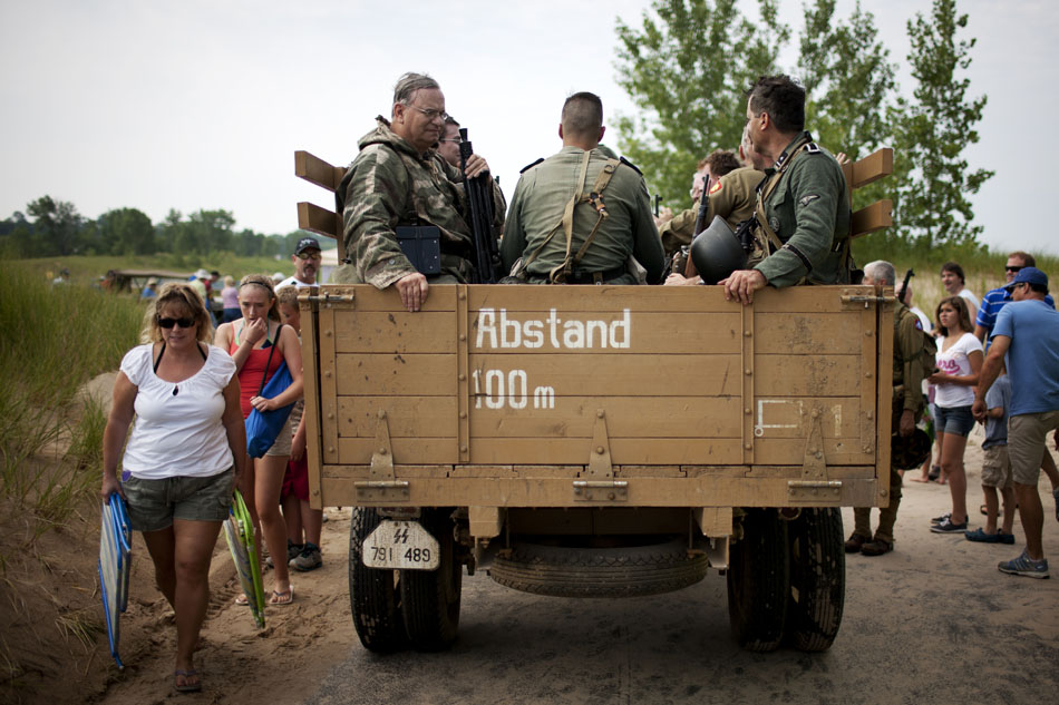 German re-enactors catch a lift from the beach after a WWII re-enactment on Saturday, June 30, 2012, at Tiscornia Beach in St. Joseph, Mich. (James Brosher/South Bend Tribune)