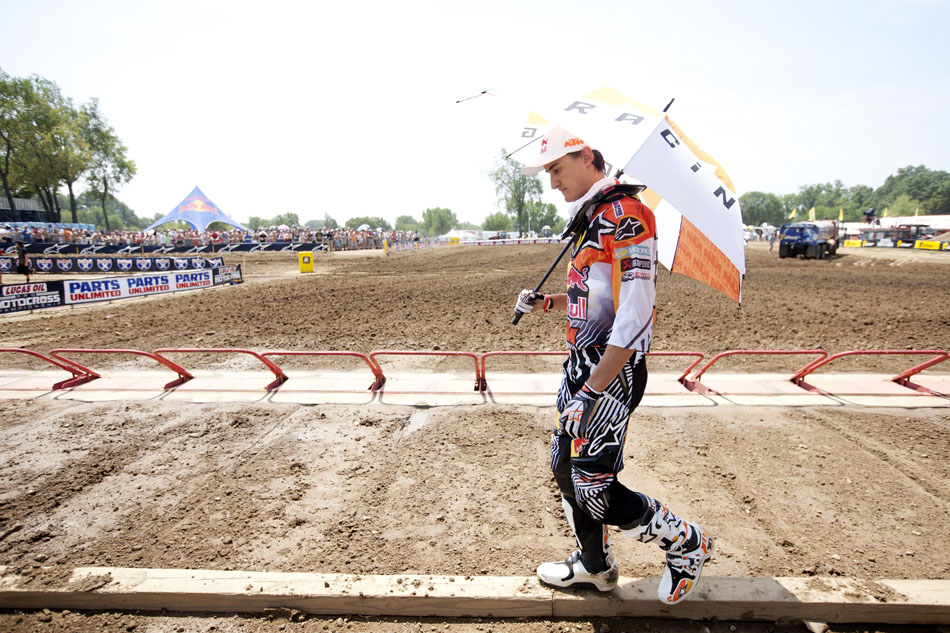 French rider Marvin Musquin examines the starting line as he uses an umbrella to shade himself from the sun before the 250 motocross race at the Red Bull Redbud National on Saturday, July 7, 2012, in Buchanan, Mich. (James Brosher/South Bend Tribune)