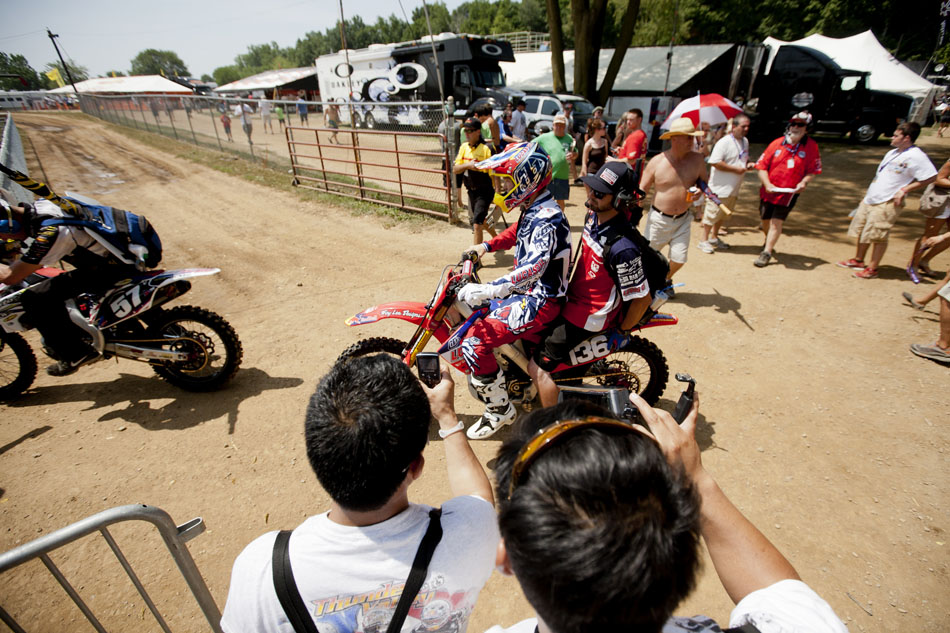 Fans photograph 250 motocross rider Jessy Nelson as he makes his way to the starting line with a member of his team during the Red Bull Redbud National on Saturday, July 7, 2012, in Buchanan, Mich. (James Brosher/South Bend Tribune)