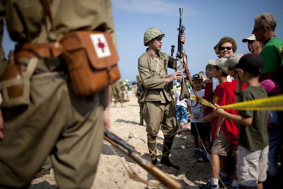 A Japanese re-enactor shows the crowd his Type 99 light machine gun before a WWII re-enactment on Saturday, June 30, 2012, at Tiscornia Beach in St. Joseph, Mich. (James Brosher/South Bend Tribune)