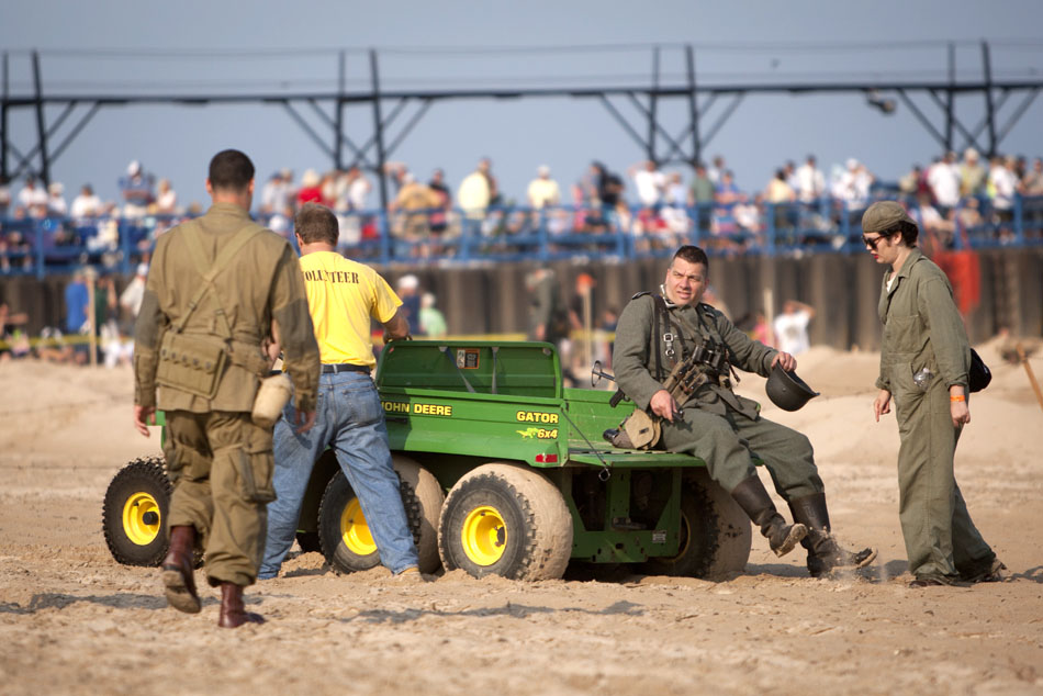 A German re-enactor helps a volunteer get a gator off the beach during a WWII re-enactment on Saturday, June 30, 2012, at Tiscornia Beach in St. Joseph, Mich. (James Brosher/South Bend Tribune)