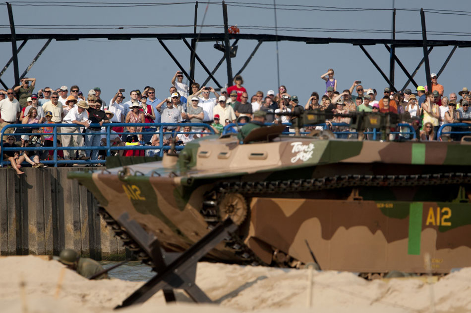 The crowd watches as Allied re-enactors make their assault on Axis positions along the beach during a WWII re-enactment on Saturday, June 30, 2012, at Tiscornia Beach in St. Joseph, Mich. (James Brosher/South Bend Tribune)