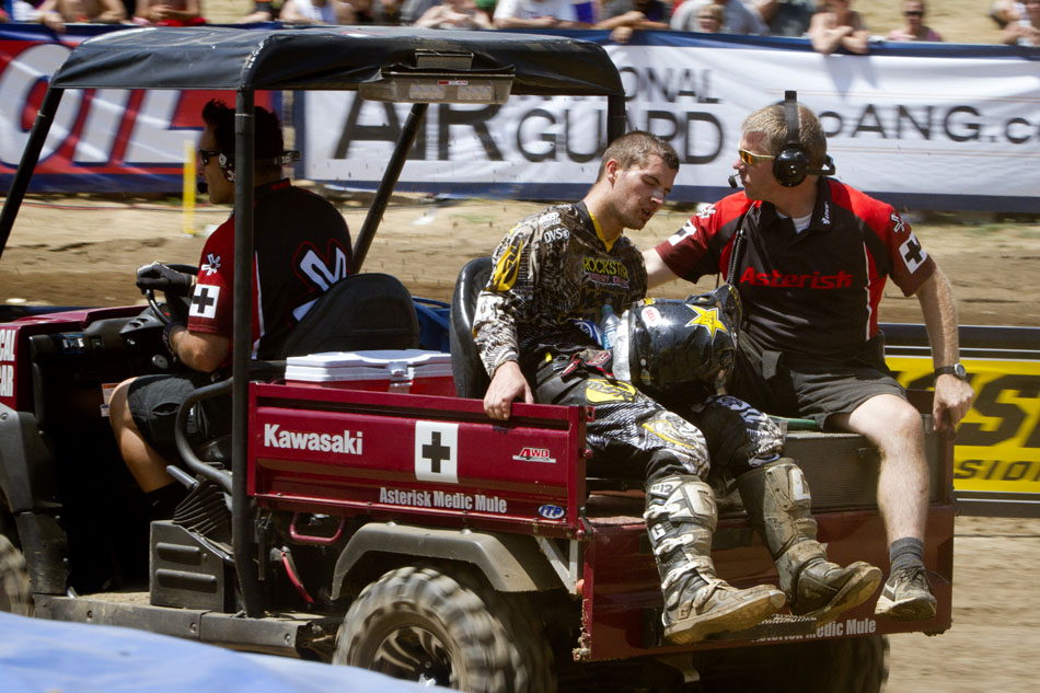 A rider leaves the track with assistance from medical personnel in the 450 motocross during the Red Bull Redbud National on Saturday, July 7, 2012, in Buchanan, Mich. (James Brosher/South Bend Tribune)