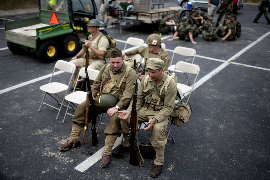 Allied re-enactors wait for a bus after a WWII re-enactment on Saturday, June 30, 2012, at Tiscornia Beach in St. Joseph, Mich. (James Brosher/South Bend Tribune)
