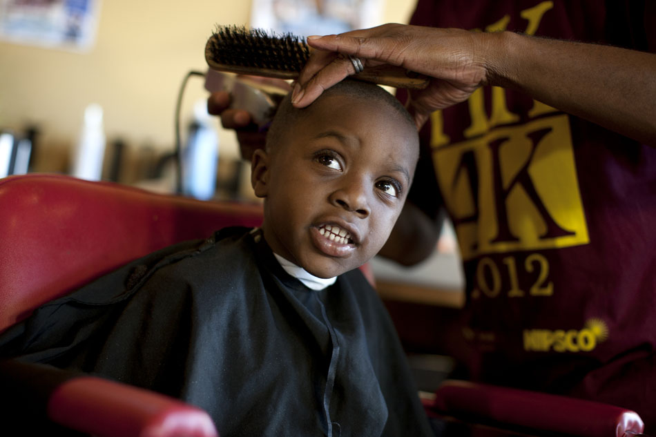 LeBron Holt, 4, a student at Mishawaka's Twin Branch Elementary, holds still as he gets a free haircut on Monday, Aug. 20, 2012, at the Monroe Circle Community Center in South Bend. The haircut was one of several free cuts given as part of the Hair Kutz 4 Kids program. (James Brosher/South Bend Tribune)