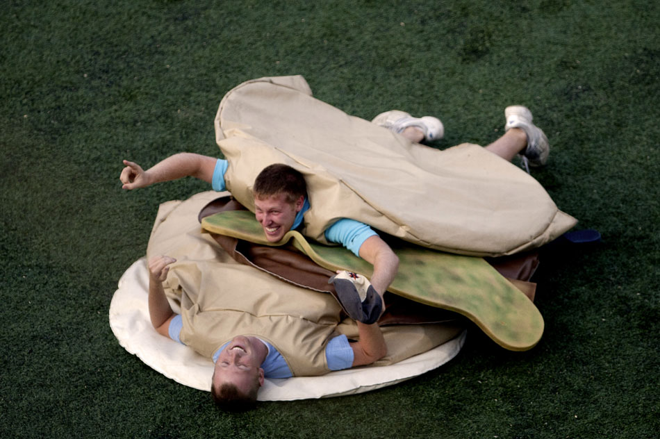 Fans celebrate as they build a human sandwich in the infield between innings during a minor league game on Wednesday, Aug. 15, 2012, at Coveleski Stadium in downtown South Bend. (James Brosher/South Bend Tribune)