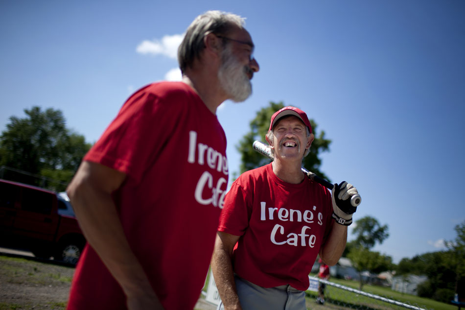 Rich Helfman, right, shares a laugh with Irene's Cafe teammate Jeff Chamberlin as the two wait to bat during a Mishawaka senior softball league game on Tuesday, July 31, 2012, at Normain Park in Mishawaka. (James Brosher/South Bend Tribune)
