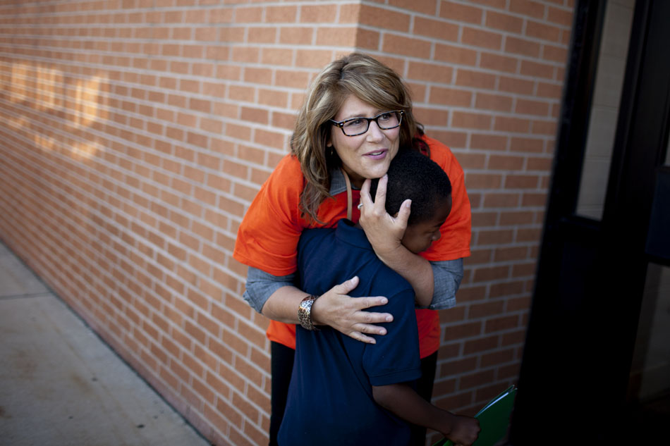 Rosie Plunkett, a teacher, embraces student Kenneth Brown during the first day of school at Tarkington Traditional School on Wednesday, Aug. 22, 2012, morning in South Bend. (James Brosher/South Bend Tribune)