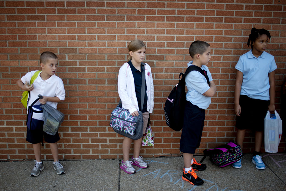 Fourth graders line up against a wall as they wait to proceed into the building for the first day of school at Tarkington Traditional School on Wednesday, Aug. 22, 2012, morning in South Bend. (James Brosher/South Bend Tribune)