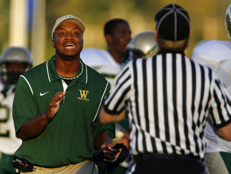 Washington coach Jay Johnson disputes a call with an official during a high school football game on Friday, Sept. 14, 2012, at Marian High School in Mishawaka. (James Brosher/South Bend Tribune)