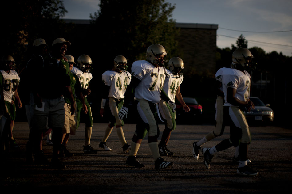 Washington players walk through the parking lot as they prepare to take the field during a high school football game on Friday, Sept. 14, 2012, at Marian High School in Mishawaka. (James Brosher/South Bend Tribune)