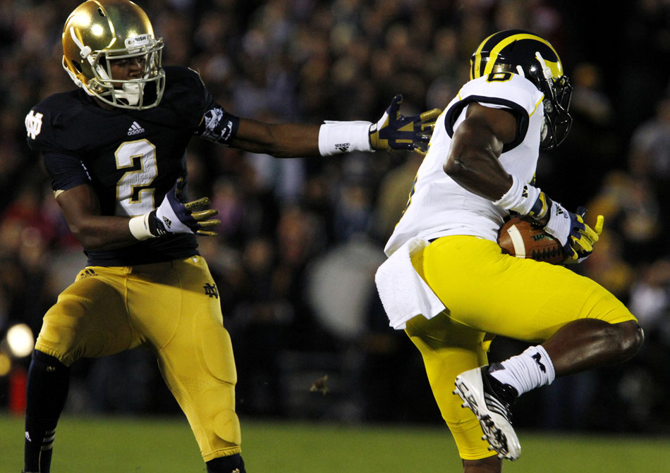 Michigan defensive back Raymon Taylor (6) intercepts a pass intended for Notre Dame wide receiver Chris Brown(2) during a NCAA college football game on Saturday, Sept. 22, 2012, at Notre Dame. (James Brosher/South Bend Tribune)