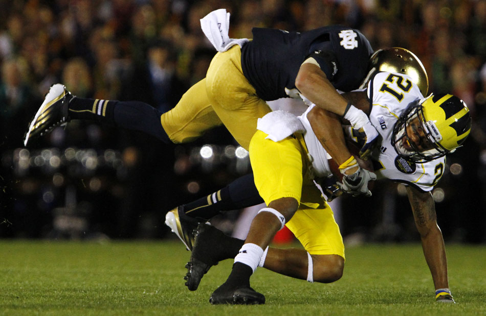 Notre Dame cornerback Bennett Jackson tackles Michigan wide receiver Roy Roundtree during a NCAA college football game on Saturday, Sept. 22, 2012, at Notre Dame. (James Brosher/South Bend Tribune)