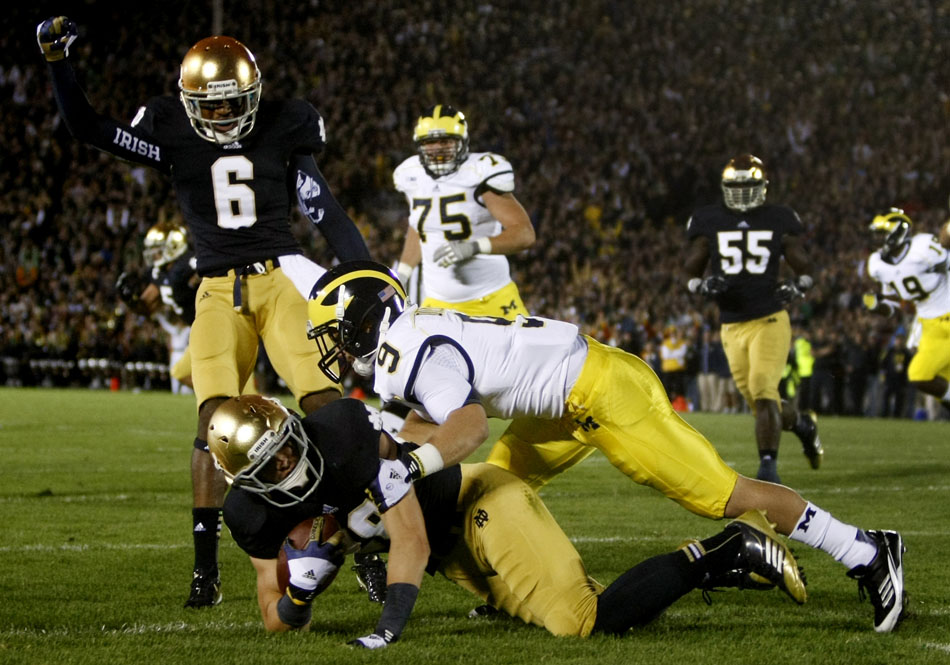 Notre Dame safety Nicky Baratti intercepts a pass from Michigan quarterback Denard Robinson in the end zone for a touchback during a NCAA college football game on Saturday, Sept. 22, 2012, at Notre Dame. (James Brosher/South Bend Tribune)