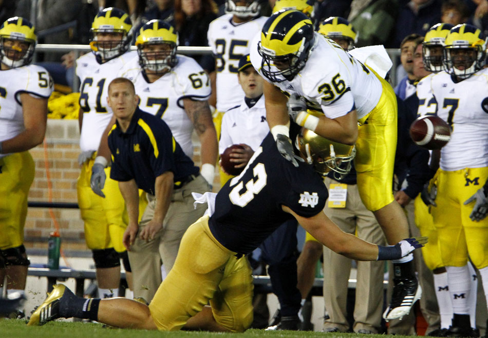Notre Dame linebacker Danny Spond lays a hit on Michigan fullback Joe Kerridge during a NCAA college football game on Saturday, Sept. 22, 2012, at Notre Dame. Spond was flagged for pass interference on the play. (James Brosher/South Bend Tribune)
