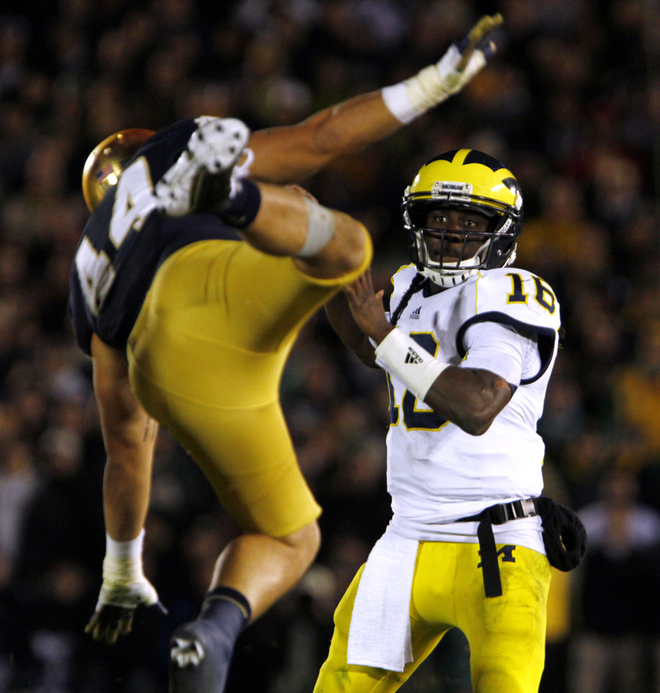 Notre Dame linebacker Carlo Calabrese flies at Michigan quarterback Denard Robinson during a NCAA college football game on Saturday, Sept. 22, 2012, at Notre Dame. (James Brosher/South Bend Tribune)