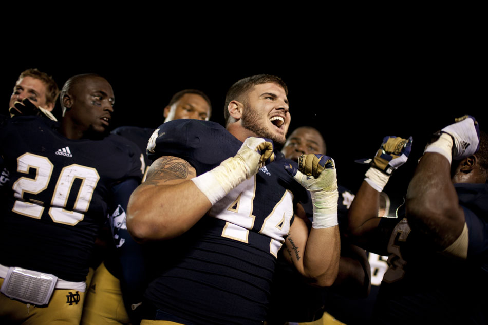 Notre Dame linebacker Carlo Calabrese (44) celebrates with his teammates after singing the alma mater following a 13-6 win against Michigan on Saturday, Sept. 22, 2012, at Notre Dame. (James Brosher/South Bend Tribune)