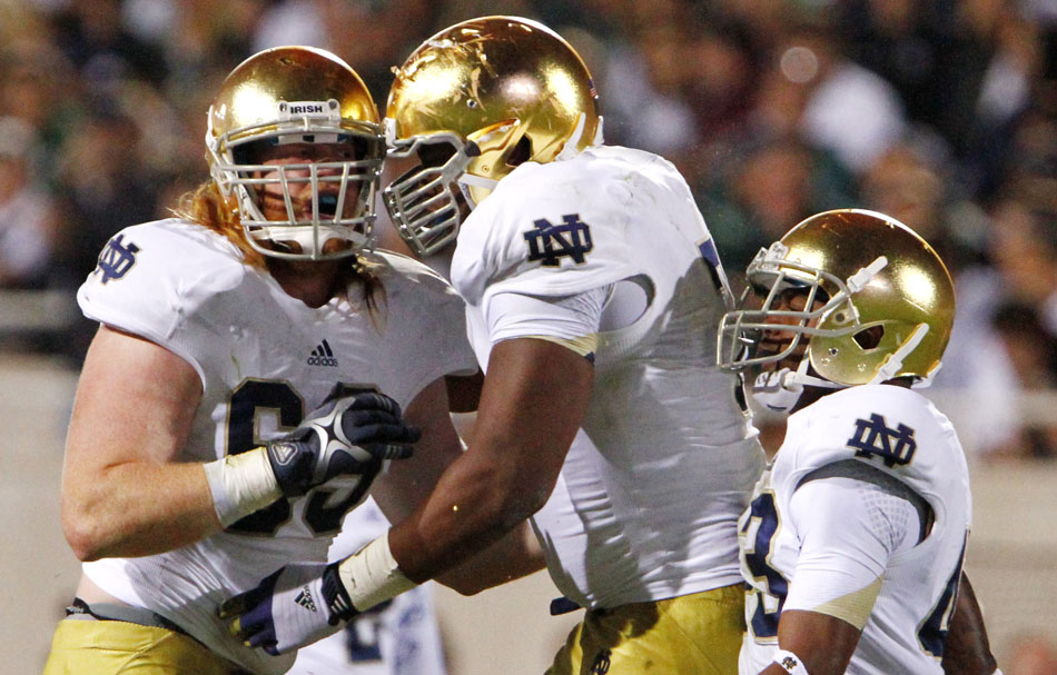 Notre Dame defensive lineman Tony Springmann, left, celebrates a defensive stop during a NCAA college football game on Saturday, Sept. 15, 2012, in East Lansing, Mich. (James Brosher/South Bend Tribune)