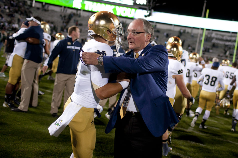 Notre Dame athletics director Jack Swarbrick greets players on the field after a 20-3 Irish win against Michigan State on Saturday, Sept. 15, 2012, in East Lansing, Mich. (James Brosher/South Bend Tribune)