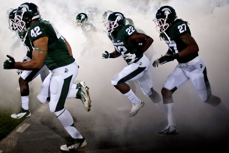 Michigan State players take the field during a NCAA college football game on Saturday, Sept. 15, 2012, in East Lansing, Mich. (James Brosher/South Bend Tribune)