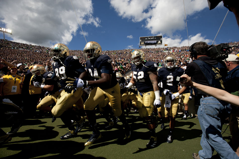 Notre Dame players run onto the field before a NCAA college football game against Purdue on Saturday, Sept. 8, 2012, at Notre Dame. (James Brosher/South Bend Tribune)