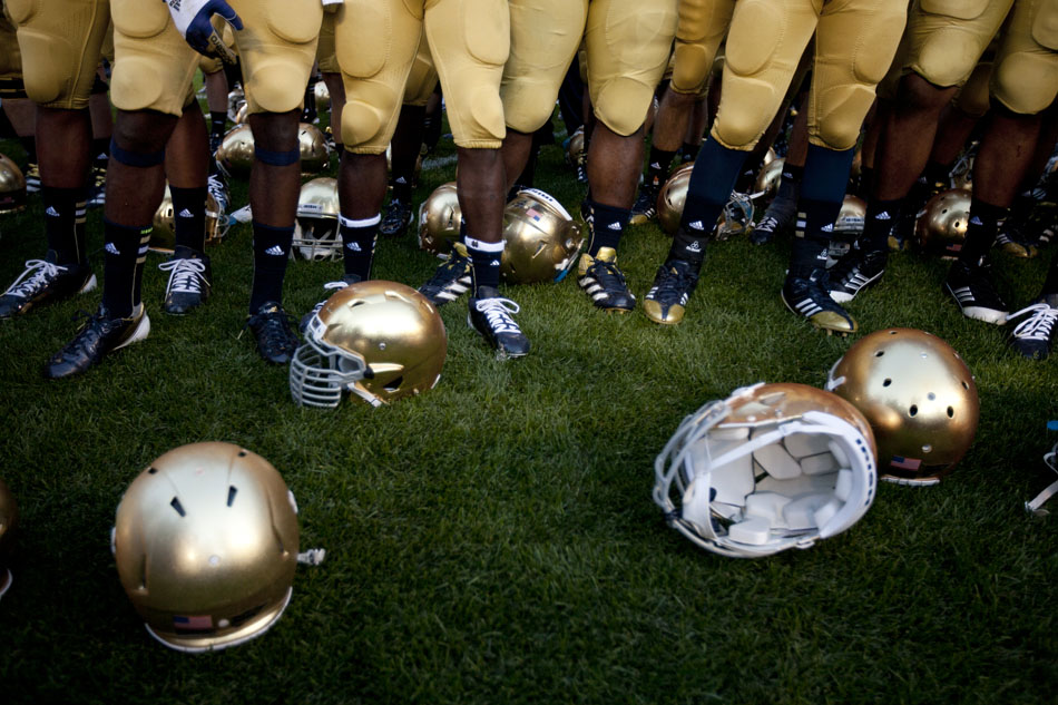 Golden helmets sit on the turf as players sing the alma mater during a NCAA college football game on Saturday, Sept. 8, 2012, at Notre Dame. (James Brosher/South Bend Tribune)
