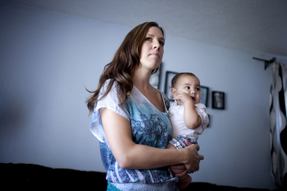 Nicole Onax Ramirez holds her son, Jonathan Ramierez, on Thursday, Aug. 30, 2012, at the family home in South Bend. Nicole's husband, Danny, was killed in 2011 after being struck by a car while riding his moped home. (James Brosher/South Bend Tribune)