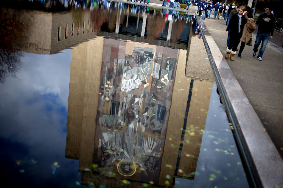 Fans make their way past the reflecting pool outside of the Hesburgh Library before a NCAA college football game on Saturday, Oct. 20, 2012, at Notre Dame. (James Brosher/South Bend Tribune)