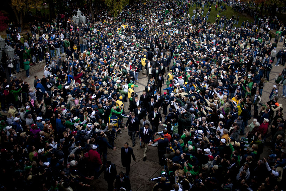 Notre Dame players make their way through fans into the stadium before a NCAA college football game against BYU on Saturday, Oct. 20, 2012, at Notre Dame. (James Brosher/South Bend Tribune)