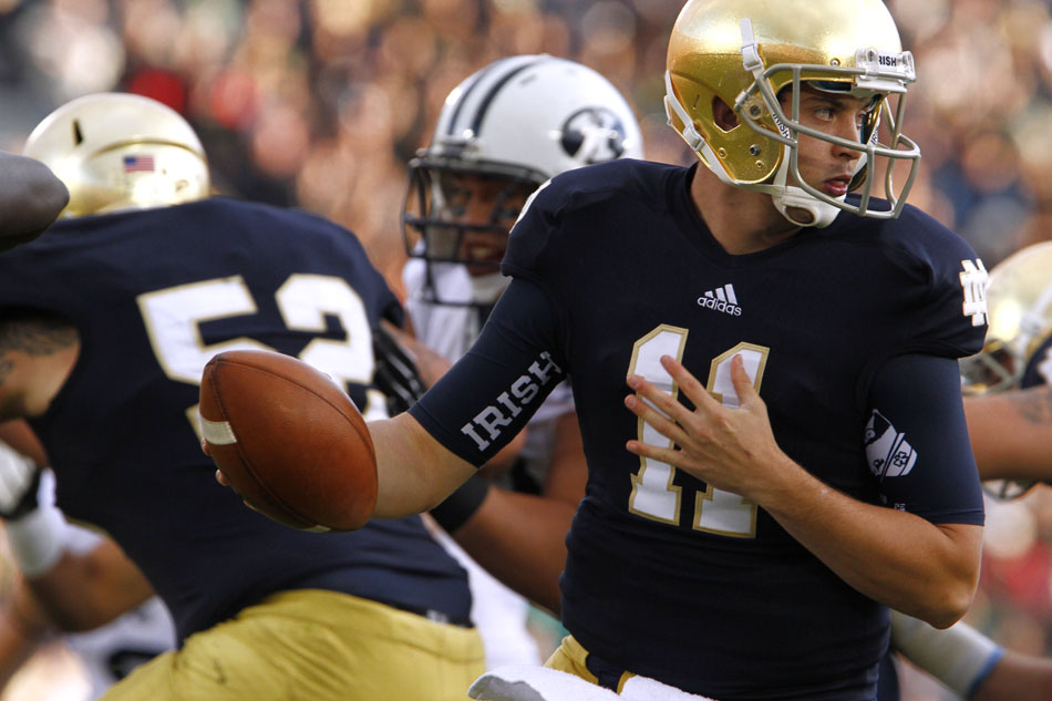Notre Dame quarterback Tommy Rees (11) fakes a hand off and rolls out to pass during a NCAA college football game on Saturday, Oct. 20, 2012, at Notre Dame. (James Brosher/South Bend Tribune)