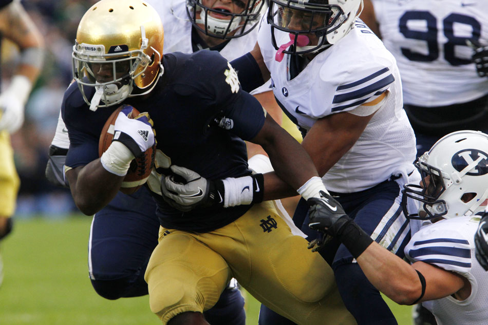 Notre Dame running back Theo Riddick (6) drags several BYU defenders with him on a long run during a NCAA college football game on Saturday, Oct. 20, 2012, at Notre Dame. (James Brosher/South Bend Tribune)