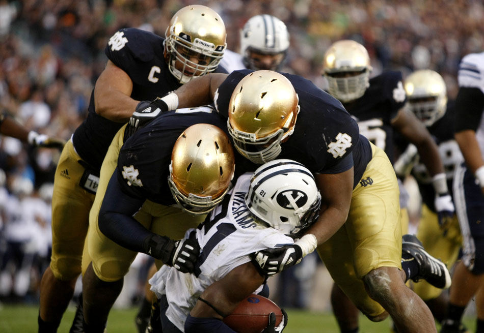 Notre Dame linebacker Manti Te'o, left, defensive lineman Louis Nix III and defensive end Stephon Tuitt drop Brigham Young running back Jamaal Williams for a big loss during a NCAA college football game on Saturday, Oct. 20, 2012, at Notre Dame. (James Brosher/South Bend Tribune)