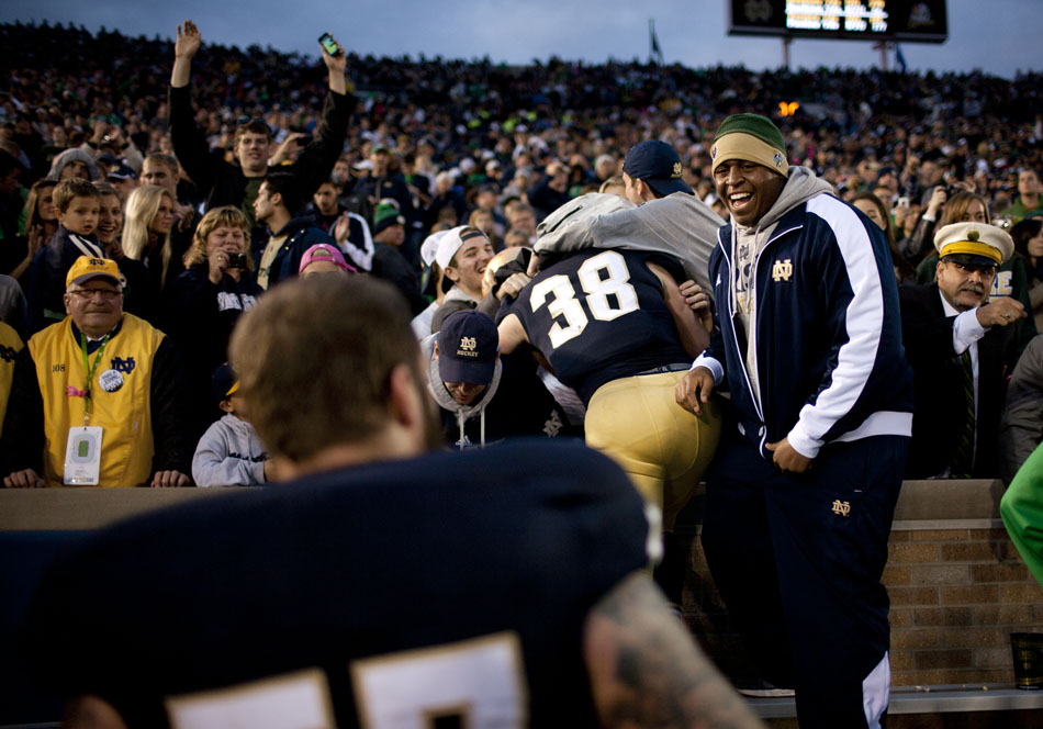 Notre Dame players celebrate with fans after a 17-14 win against BYU on Saturday, Oct. 20, 2012, at Notre Dame. (James Brosher/South Bend Tribune)