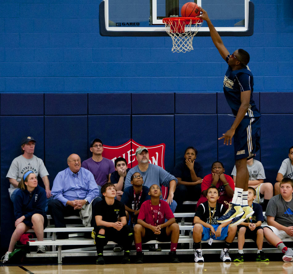 Fans watch as Notre Dame forward Eric Katenda dunks the ball during an open practice on Tuesday, Oct. 23, 2012, at the Kroc Center in South Bend. (James Brosher/South Bend Tribune)