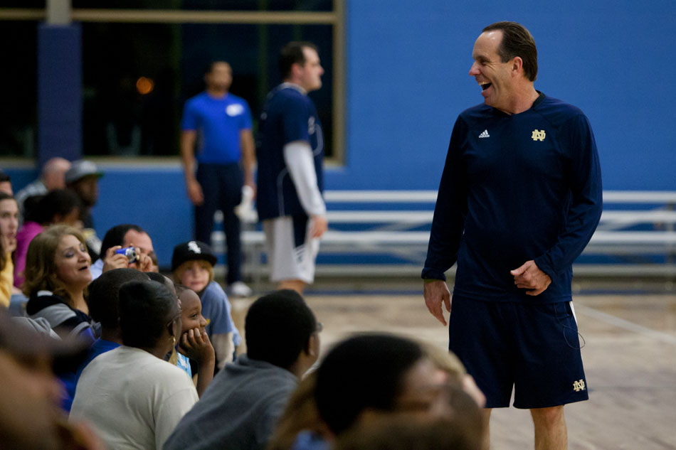 Notre Dame coach Mike Brey share a few laughs with members of the crowd during a break in an open practice on Tuesday, Oct. 23, 2012, at the Kroc Center in South Bend. (James Brosher/South Bend Tribune)