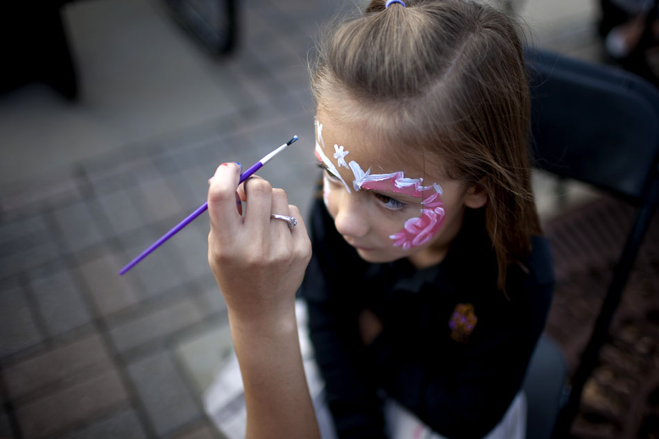 Sophie Pairitz, 6, concentrates as she gets her face painted during a Halloween Fun Fair on Wednesday, Oct. 24, 2012, at Indiana University-South Bend. Face painting was one of the most popular activities at the event. (James Brosher/South Bend Tribune)